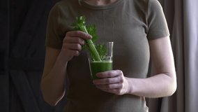 woman with celery juice in a glass at home 