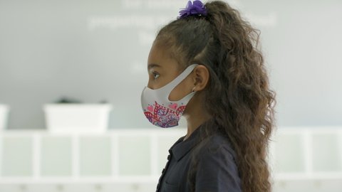 Health and Safety. A child gets her temperature checked during global pandemic before entering her classroom. Shot in 4k. 