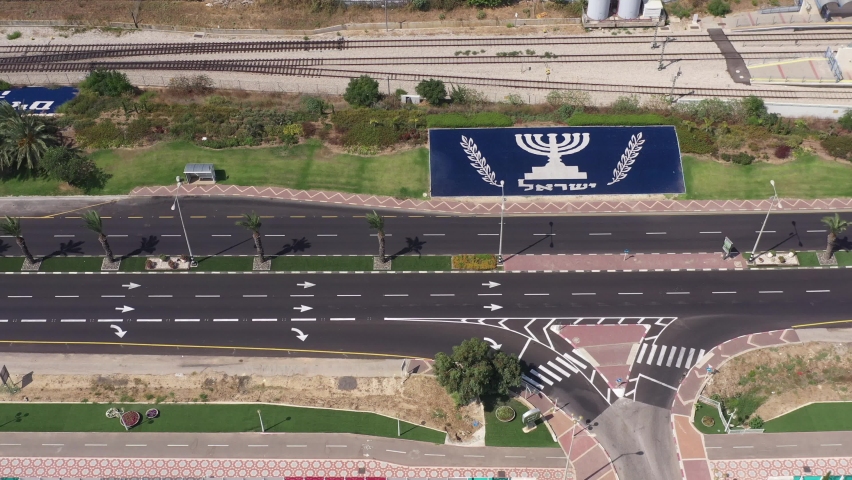 Corona Virus second lockdown, empty highway road with large Menorah of Israel and welcome to Nahariyya Hebrew sign, south of the city of Nahariyya, Aerial view.