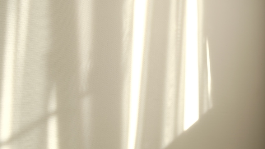 Morning sun lighting the room, shadow background overlays. Waving white tulle near the window. Royalty-Free Stock Footage #1059456563