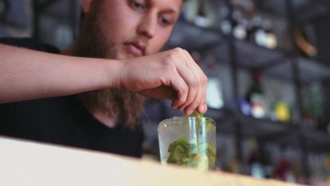 Barman With Beard Preparing A Mojito In A Cocktail Bar.