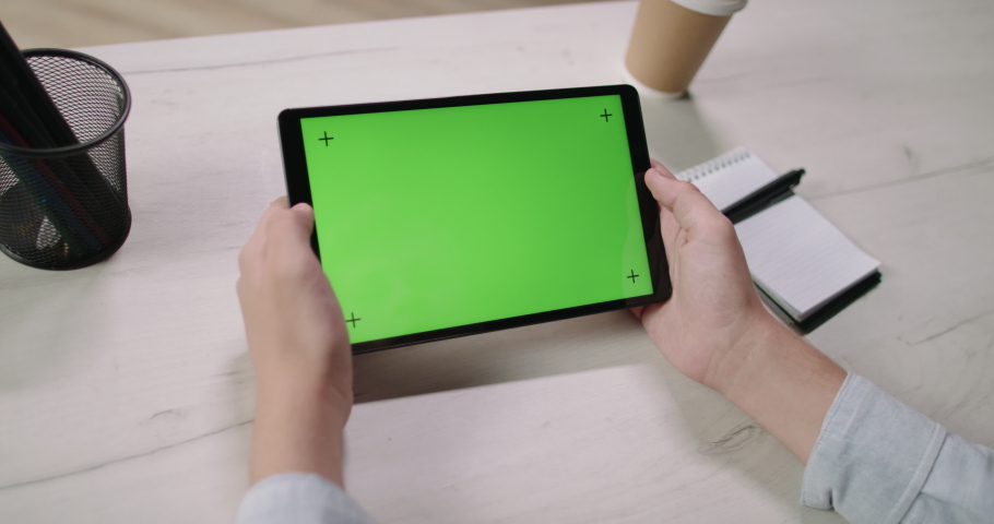 Close up shot of hands golding a tablet computer with mock up chroma key green screen. Template for online education and video conferences 4k footage Royalty-Free Stock Footage #1059465221