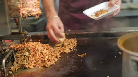 A cook is making tacos in a mexican street food restaurant