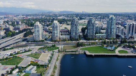 Aerial view of buildings in Vancouver and passing skytraing. Highway around