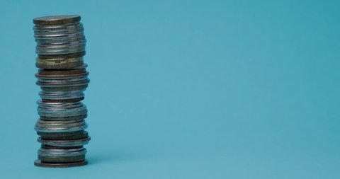 a stack of coins on a blue background close up