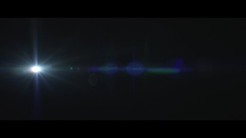 A blue lens flare moving on the left side over a black background captured using a 50mm anamorphic lens from the Lucent Panorama collection - Lens Flare Video Element.