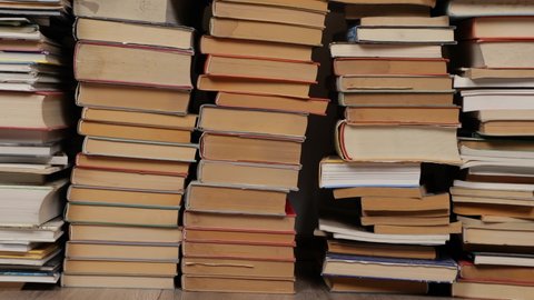 Many books in a pile on the attic, panning background