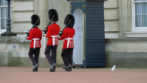 London, UK - April, 2019: Change of guards at Buckingham Palace. Infantry sentries of Queen's Guard respect a strict protocol when changing of the guard. Sentry on duty at Buckingham Palace.