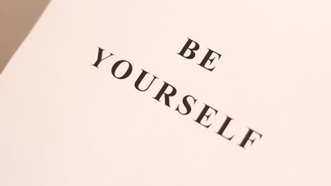 "Be Yourself" text printed on the sheet paper.