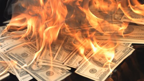 slow motion dollars money on fire lost money , go on business bitcoin down arrow loser , project new start ,firying money usd ,losers ,coins  .
