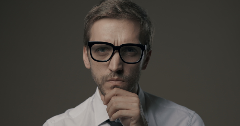 Man staring at camera and holding glasses, he is confused and has vision problems | Shutterstock HD Video #1059484430