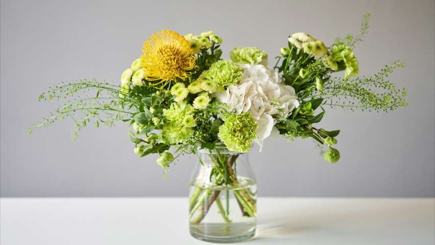 Stop motion, step by step installation of flowers in a vase. Flowers bunch, set for home. Fresh cut flowers for decoration home. European floral shop. Delivery fresh cut flower. | Shutterstock HD Video #1059488756
