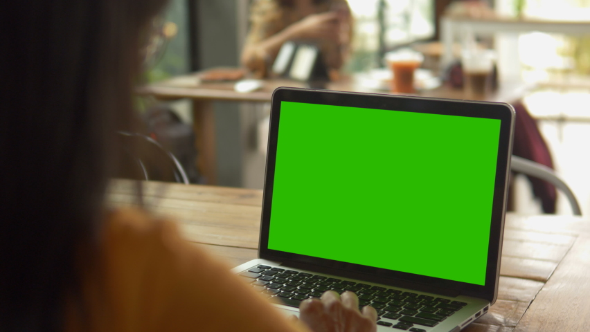 Over the shoulder shot of woman, using finger with keyboard for typing touch. computer laptop with blank green screen chroma key. | Shutterstock HD Video #1059489533