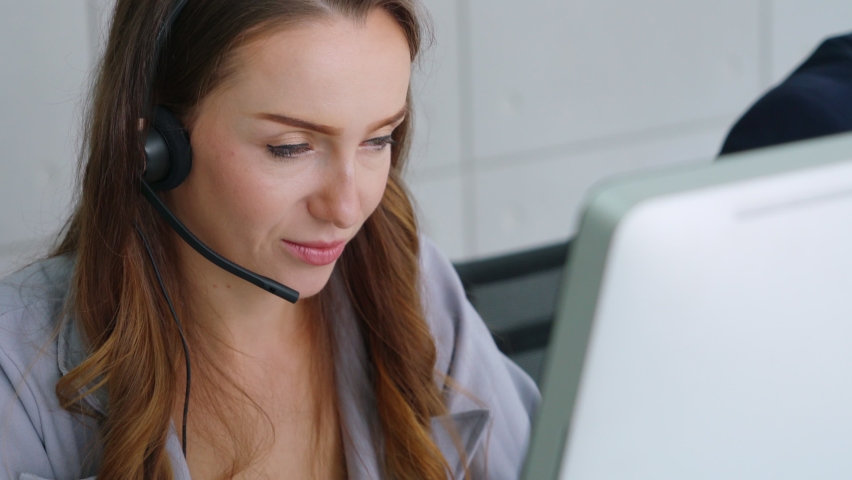 Business people wearing headset working in office to support remote customer or colleague. Call center, telemarketing, customer support agent provide service on telephone video conference call. Royalty-Free Stock Footage #1059497846