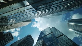 Time lapse of low angle view of city skyline buildings, blue sky and glass mirrored facades. - Powered by Shutterstock - Get 15% off with code: PIKWIZARD15