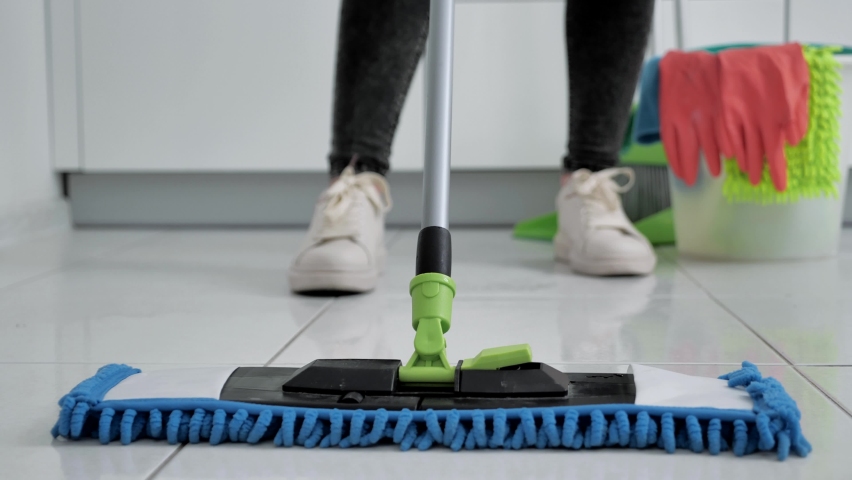 Woman washing white kitchen floor with special swob, cleaning service, close-up | Shutterstock HD Video #1059514208