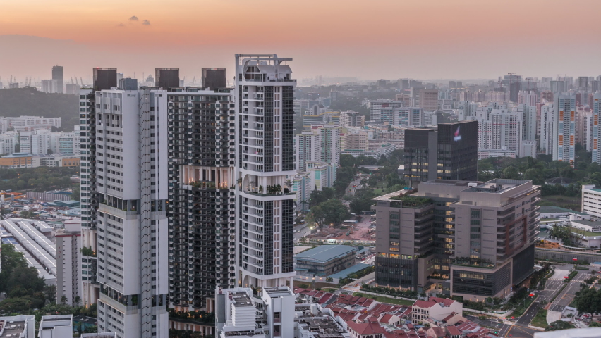 Aerial skyline with apartment buildings and skyscrapers of Singapore timelapse. Traffic on streets. View from skybridge vewpoint during sunset