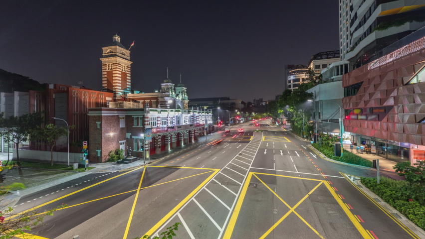 Street traffic near the fire station of Singapore night to day transition aerial timelapse. The Central Fire Station is the oldest existing fire station in Singapore on Hill street