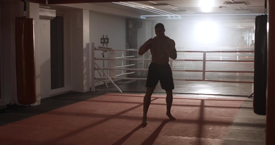 Boxing, athletic man fighter trains his punches and beats, training day in the boxing gym. | Shutterstock HD Video #1059521432