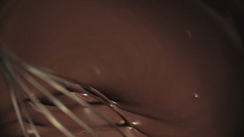 Whisking hot melted chocolate. Shoot on Digital Cinema Camera in slow motion ProRes 422 codec.