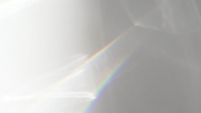 Abstract water texture overlay effect, rays of light  shadow overlay effect with rainbow reflection of light from water on a white background, mockup and backdrop Royalty-Free Stock Footage #1059523778