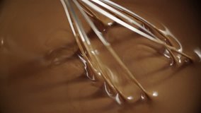 Whisking hot melted chocolate. Shoot on Digital Cinema Camera in slow motion ProRes 422 codec.