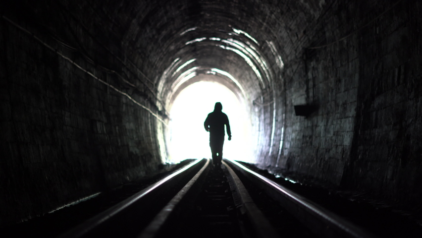 A person walking in a train tunnel