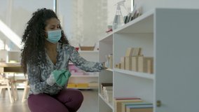 Back to school cleaning. A teacher sanitizes her classroom in preparation for students return during a pandemic. Shot in 4k. - Powered by Shutterstock - Get 15% off with code: PIKWIZARD15