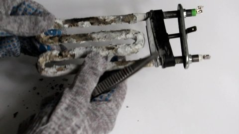 Electric heater and corrosive water heater heating elements with scale and sediment. Damaged electric heater. Repair of washing machines.