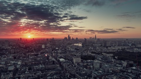 Establishing Aerial View Shot of London UK, stunning colorful sunrise, whole city skyline from Mayfair, United Kingdom
