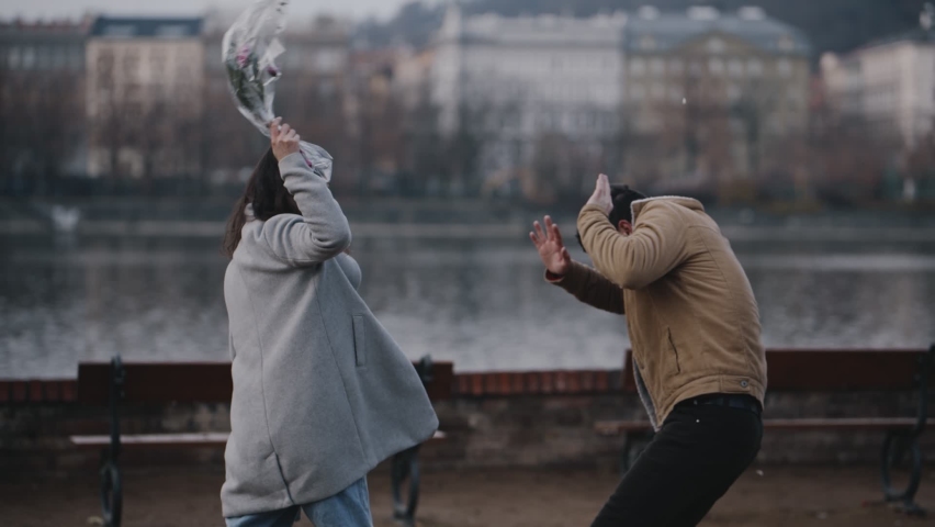 Quarrel on date on 8 march, valentine day or international women day. Young asian girl arguing with guy because of cheating. Woman screaming and beating man with bouquet of flowers for treason. Royalty-Free Stock Footage #1059538718