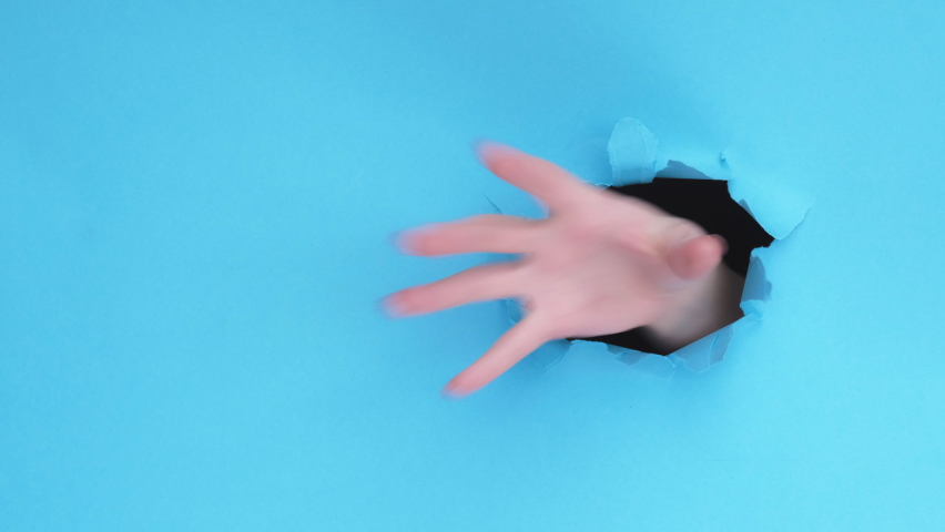 Grabbing gesture. Breakthrough hole. Female thief hand catching pulling copy space isolated on blue ripped paper wall. Commercial background. Advertising banner set of 5 loop.