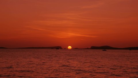 Setting sun at the sea between islands