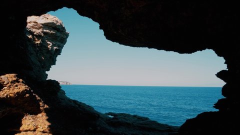 Cave overlooking sea horizon on summer day