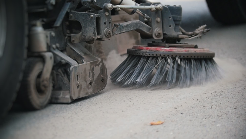 Machine clears the asphalt with a sweeper from the concrete dust Royalty-Free Stock Footage #1059545381