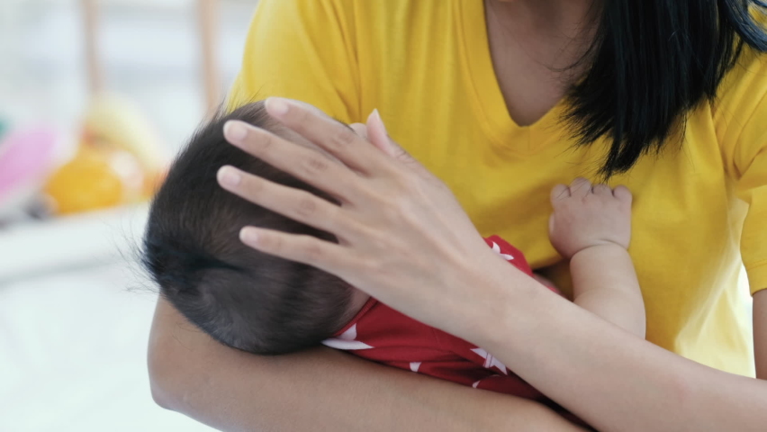Asian mother takecare her cute baby sleeping on the mother