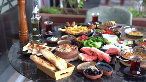 Turkish breakfast on the table in restaurant. Camera moves above the table.