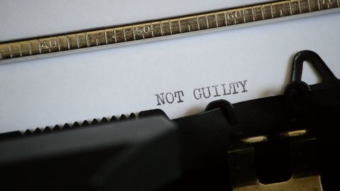 Typing the expression NOT GUILTY with an old manual typewriter