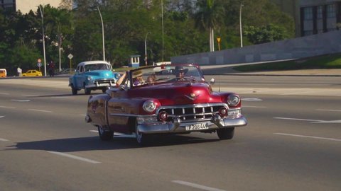 havana / Cuba - 01 16 2020: Handheld tracking shot of vintage cars in Havana, Cuba.
