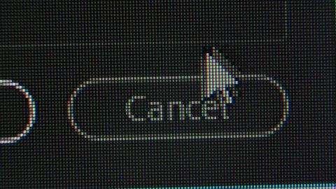 The cursor pointing arrow moves across the screen and clicks the Cancel icon. Screen monitor pixels close up. Red, blue and green subpixels create the image on the screen.