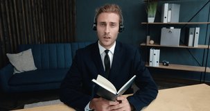 Confident Young Coach, Mentor, Business. Handsome Freelancer Businessman is holding Online Conference from Home Office, wearing Suit, Headphones.