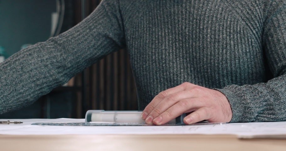Middle-aged Handsome Architect working at his Office with Ruler and Pencil, Looking serious. Having Confident look and thinking about his Project. Hardworking with Drawings and Blueprints. Royalty-Free Stock Footage #1059571184