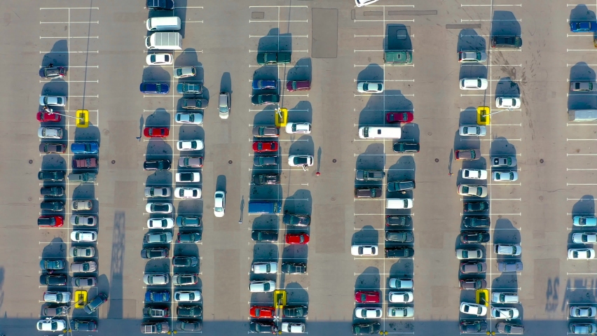 Aerial top down view of the parking lot with many cars of supermarket shoppers in the city grocery store | Shutterstock HD Video #1059571835