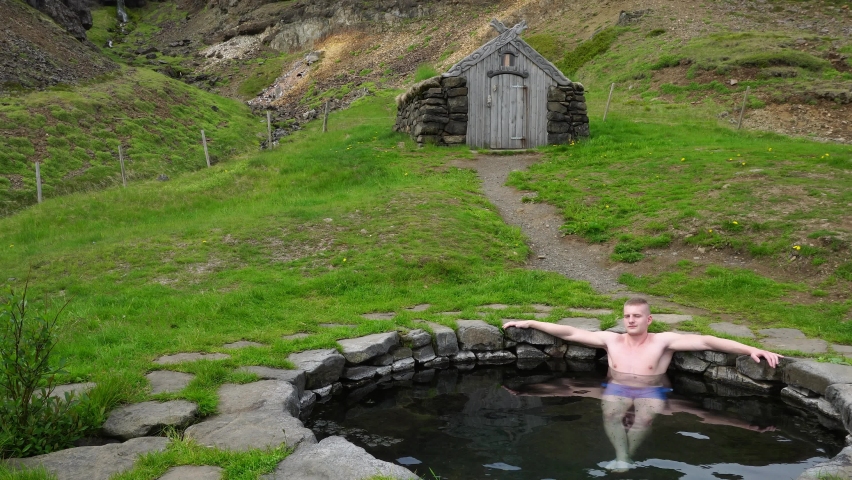 Gudrunarlaug Hot Pool located in west Iceland with a person in it. 4K UHD video.