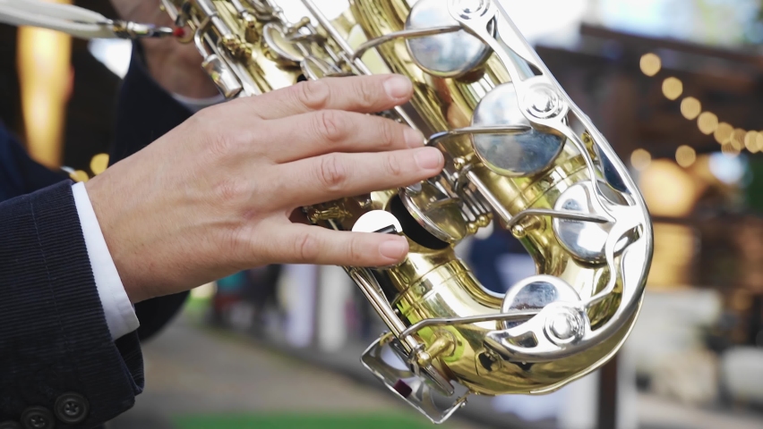 Close-up of a saxophonist's hands during a performance. musician playing outdoors Royalty-Free Stock Footage #1059579494