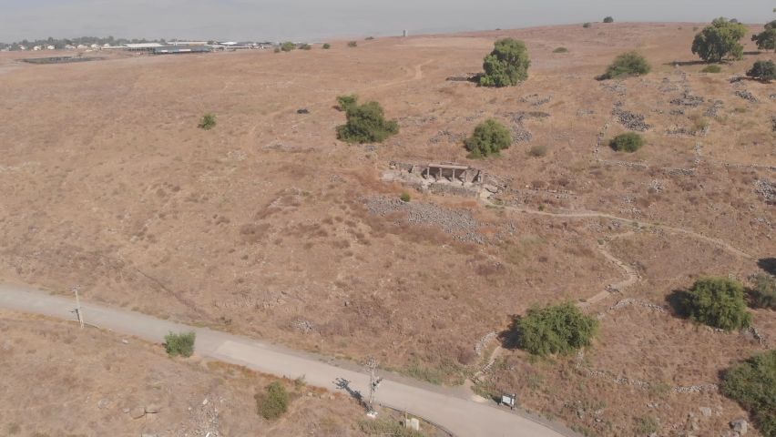Mountain slope with ruins of an ancient synagogue Deir Aziz in the settlement of Kanaf in the Golan Heights in northern Israel. Drone filming.