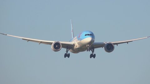 Amsterdam, Netherlands – 1 September 2020: A Boeing 787 Dreamliner of Tui Netherlands landing at Amsterdam Schiphol Airport (AMS) in the Netherlands. Boeing is an Aircraft manufacturer from Seattle, U