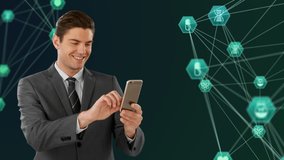 Digital composite video of businessman smiling while using smartphone and two globes of green medical icons spinning against black  background. Global networking and business concept