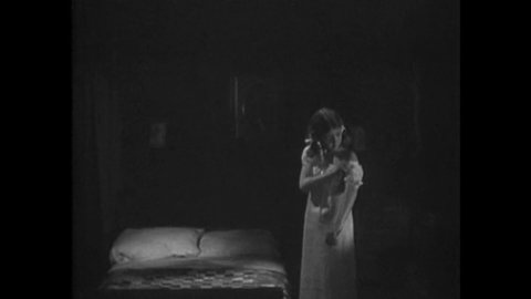 CIRCA 1938 - In this exploitation movie set in a rural region, a girl says her prayers before her husband plans to come to bed, but he is shot dead.