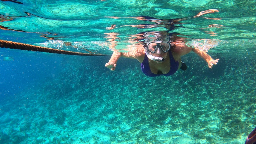 Woman snorkeling at a natural pool | Shutterstock HD Video #1059600896